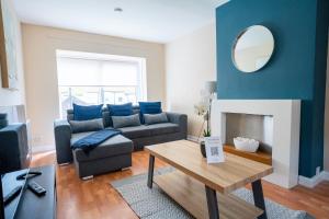 a living room with a couch and a table at Marina House in Bathgate