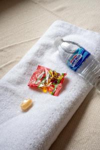 a bottle of toothpaste and a snack on a napkin at 2 BDR House By Caledonia Luxe Stays Short Lets & Serviced Accommodation Bathgate in Bathgate