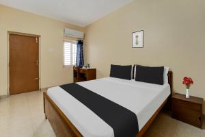 Postel nebo postele na pokoji v ubytování Super Hotel O Chinnamuthu Main Street
