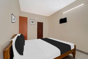 Postel nebo postele na pokoji v ubytování Super Hotel O Chinnamuthu Main Street