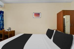 Postel nebo postele na pokoji v ubytování Super Hotel O Chinnamuthu Main Street