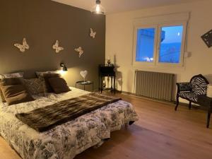 a bedroom with a bed with butterflies on the wall at Gite Nicole in Jeuxey