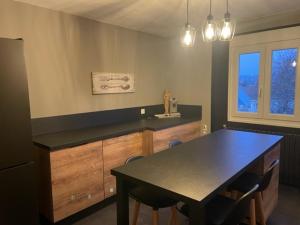 a kitchen with a table and a counter with chairs at Gite Nicole in Jeuxey +15 photos