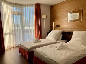 a hotel room with two beds and a window at Haus Alexander in Frechen +13 photos
