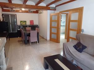 a living room with a table and a couch at Los Iris Solo Familias Serviplaya in Playa de Gandia