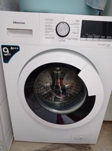 a white washing machine with its door open at Los Iris Solo Familias Serviplaya in Playa de Gandia