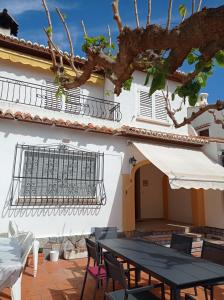 a patio with a table and chairs and a building at Los Iris Solo Familias Serviplaya in Playa de Gandia