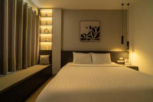 a bedroom with a large white bed and a window at 237 Thanh Nhan Studios in Hanoi