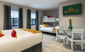 a bedroom with a bed and a table and a bed and a room at Nannys in Duleek +16 photos