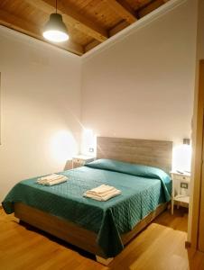a bedroom with a bed with two towels on it at Guest House Lo specchio sul mare in Santa Flavia