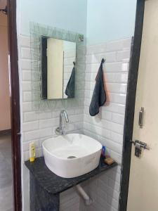 a bathroom with a sink and a mirror at Hari Prasad Homestay in Shirdi +10 photos