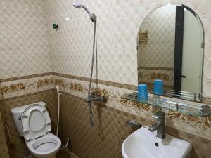a bathroom with a toilet and a sink and a mirror at Công Thành Hotel 1 in Lao Cai +56 photos