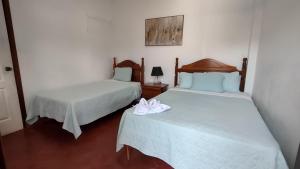 Een bed of bedden in een kamer bij Hotel Casa de Copan