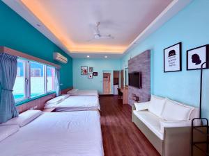 a room with four beds and a tv at I WoW in Xiaoliuqiu