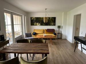 a living room with a couch and a table at Strandperle in Harrislee