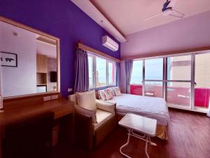 a bedroom with a bed and a desk and window at I WoW in Xiaoliuqiu
