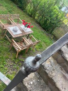 a metal railing with a wooden table and a table and bench at Casa A Boga RIBEIRA SACRA in Abeleda