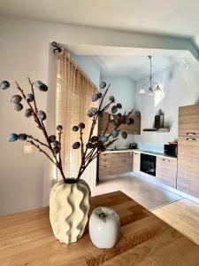 a living room with a vase with a plant in it at Apartments Terra Solaris in Medulin