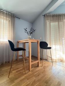 a table and two chairs in a room at Apartments Terra Solaris in Medulin