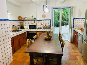 a kitchen with a wooden table with a bowl of fruit on it at Les Cèdres in Valleraugue