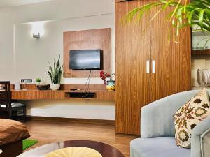 a living room with a tv and a couch at SkyNest in Dehradun