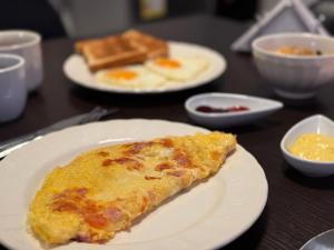 a slice of pizza on a white plate on a table at Air Guest House - con Desayuno & Jacuzzi Social in Medellín