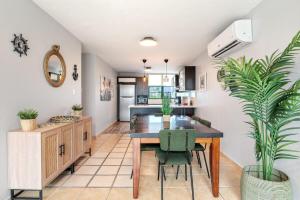 a kitchen and dining room with a table and plants at The Best PentHouse In Aquatika Pool Front in Vieques