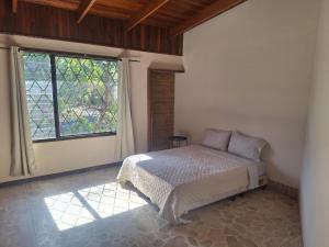 Ένα ή περισσότερα κρεβάτια σε δωμάτιο στο Carolina Hostel