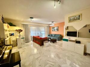 a large living room with a couch and a table at Flisvos Elite Seafront Luxury Apartment in Athens