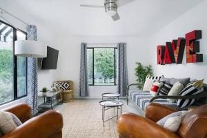 a living room with a couch and a table at Hotel El Cid by AvantStay Mid-Century Charm with Poolside Cabanas in Palm Springs