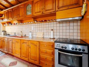 a kitchen with wooden cabinets and a stove at Alexandra House in Kríni
