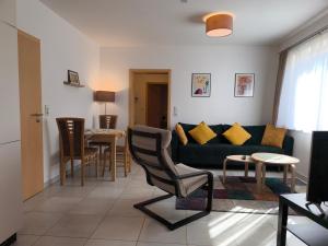 a living room with a couch and a table at Ferienwohnung Ries am Weinberg in Platten