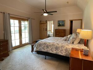 a bedroom with a bed and a ceiling fan at Rose Hill Farms- Relax at Your 12 Acre Farmhouse Retreat ! in Brenham