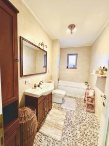 a bathroom with a sink and a toilet and a mirror at Apartament elegant - Cozy home residence in Piteşti