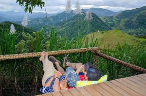 a group of people laying in a hammock on a mountain at Ecobindu-Domo in Albán