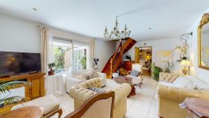 a living room with couches and a flat screen tv at Magnifique villa La Fenière En Provence in Aubagne