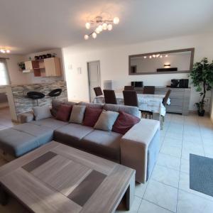 a living room with a couch and a table at Maison moderne au centre d'Oléron in Dolus d'Oléron