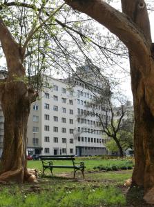 a park bench in front of a large building at Urban Boutique Hotel Center in Ljubljana