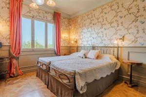 a bedroom with a bed and a window at Tenuta Merlò in Castagneto Carducci +17 photos