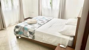 a bedroom with a bed with a blanket on it at Villa Chanel avec piscine proche de la plage in Grand-Baie +14 photos
