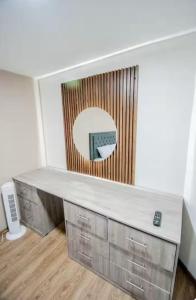 a desk in a room with a mirror on the wall at Hotel Boutique Casa Teresita in Medellín
