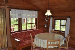 a dining room with a red couch and a table at Hinders Cottages in Nauvo