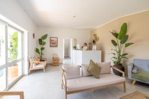 a living room with a couch and a counter at The Lighthouse Hostel in Sagres +57 photos