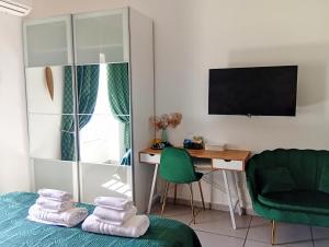 a room with a bed and a desk with a monitor at Megaride Santa Lucia in Naples