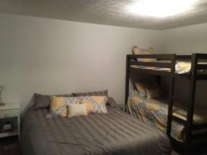 a bedroom with a bed and two bunk beds at The Westender in Hessel
