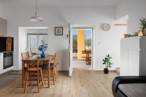 a kitchen and dining room with a table and chairs at Apartment Miha in Loborika
