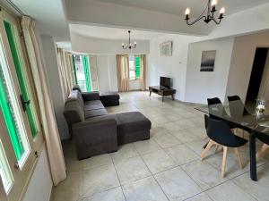 a living room with a couch and a table at Private room in shared flat in Nicosia