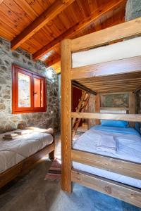 a bedroom with two bunk beds in a cabin at Vavouledo Village House in Khamalévri