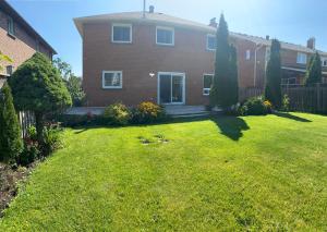 a house with a yard with a grass yard at Bright Private Single Bedroom Q33 in Mississauga
