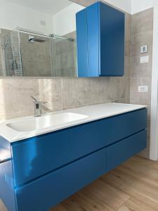 a bathroom with a blue sink and a mirror at The VIEW - Spacious modern apt in Como +5 photos